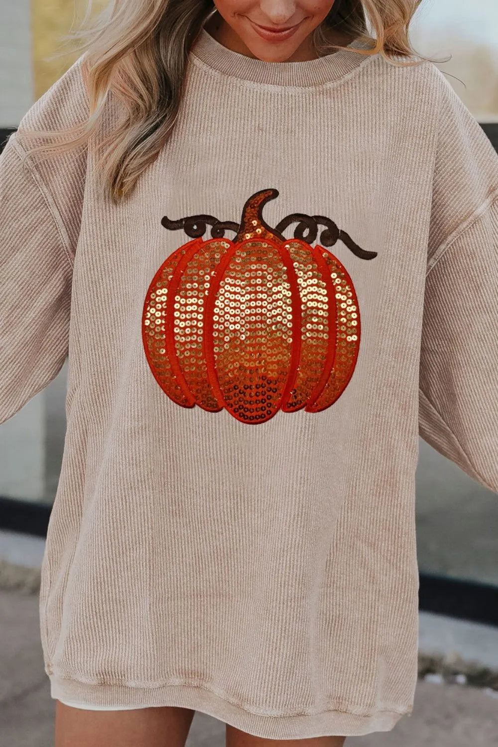 Long sleeve round neck sweatshirt with sequin pumpkin design in cozy polyester fabric