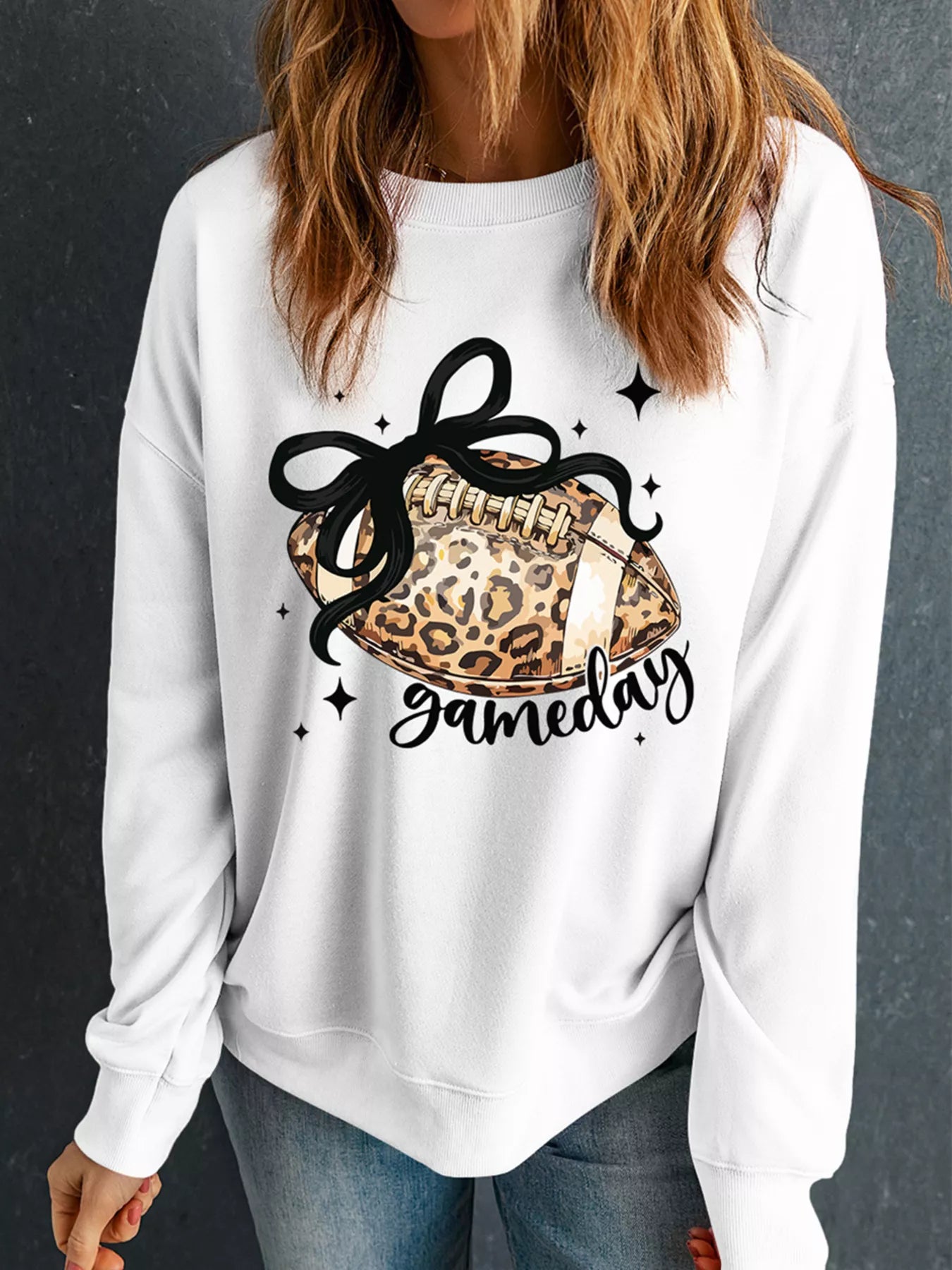White crew neck sweatshirt with leopard football and gameday graphic.
