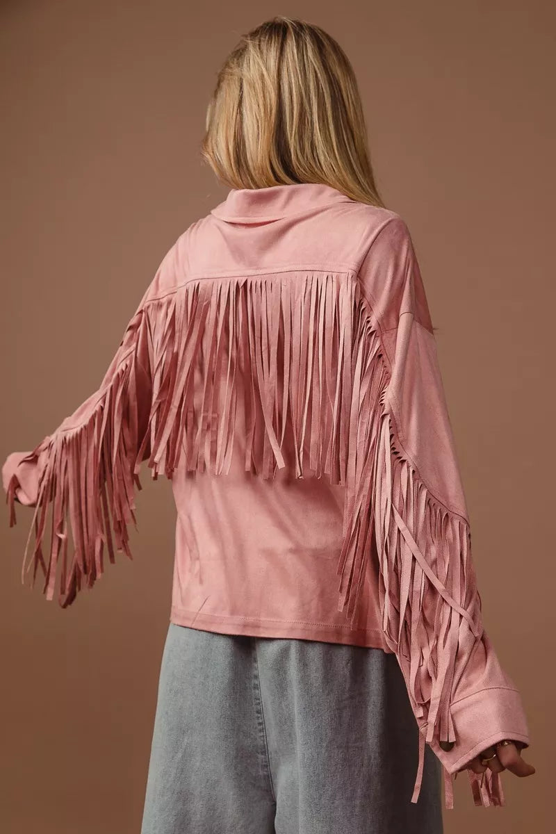 Back view of a pink suede fringe long sleeve jacket on a model.