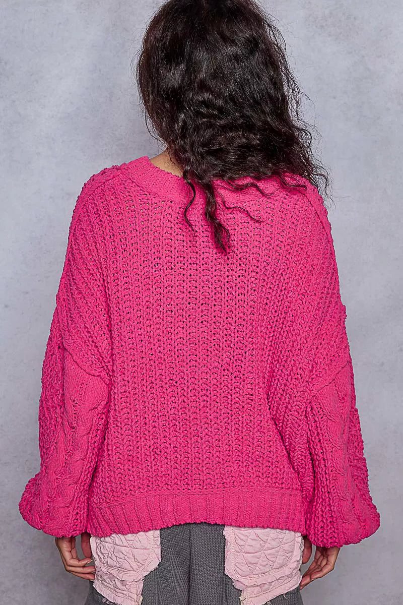 Back view of pink chenille cable-knit V-neck cropped sweater with balloon sleeves.