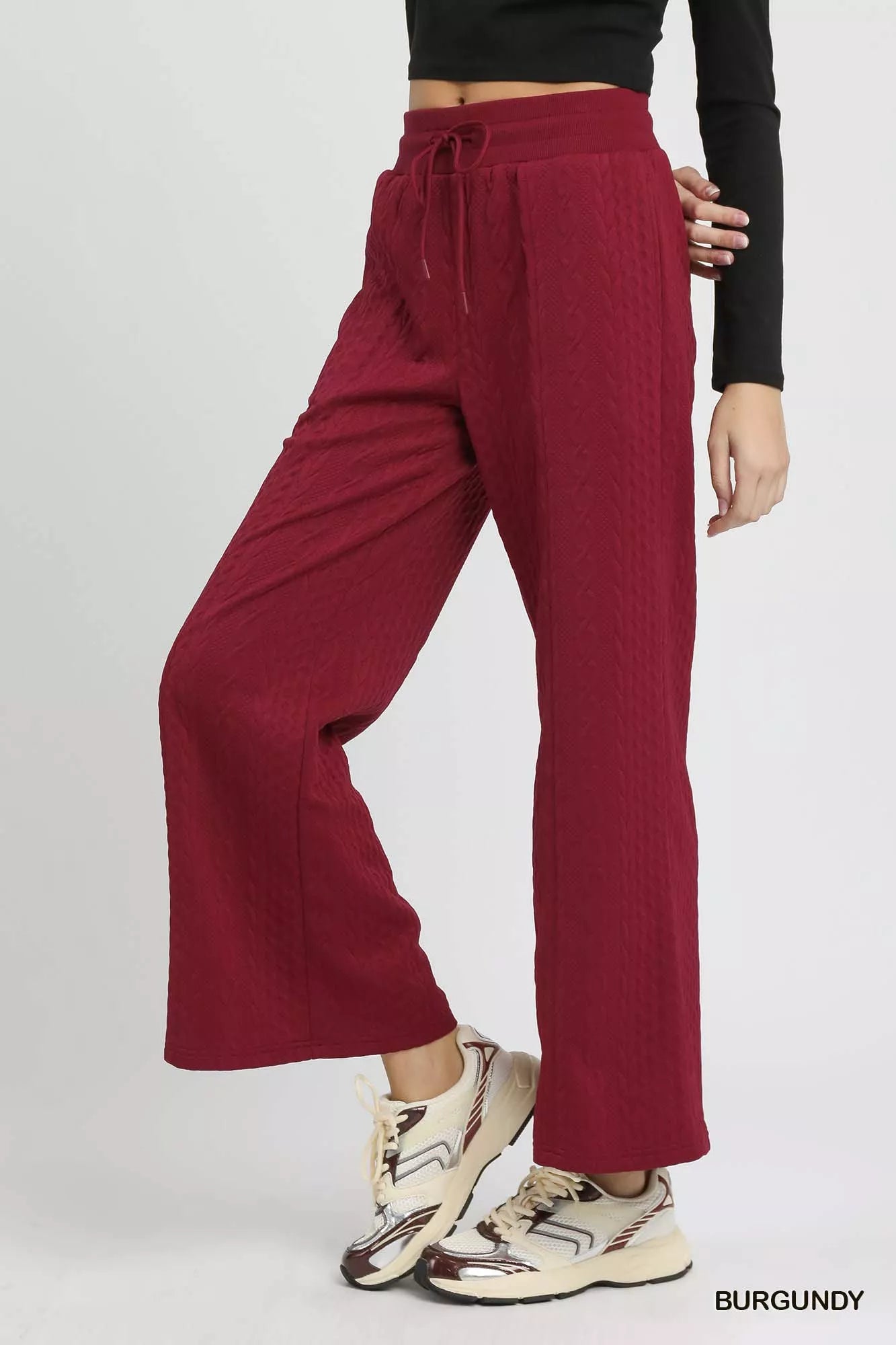 Wide-leg cable knit textured pants in burgundy with drawstring waist.