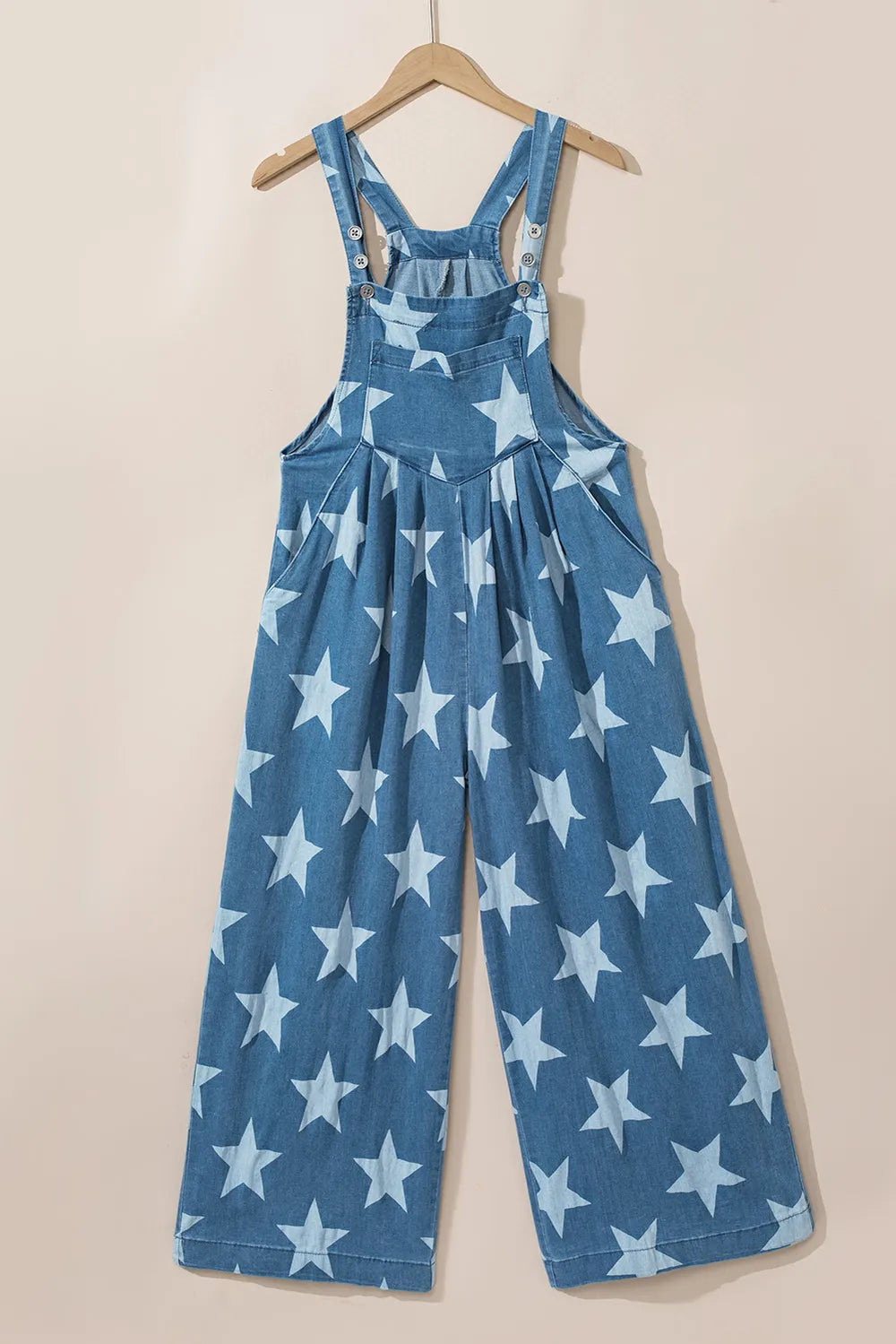 Wide leg denim overalls with star print and pockets in a cotton blend fabric.