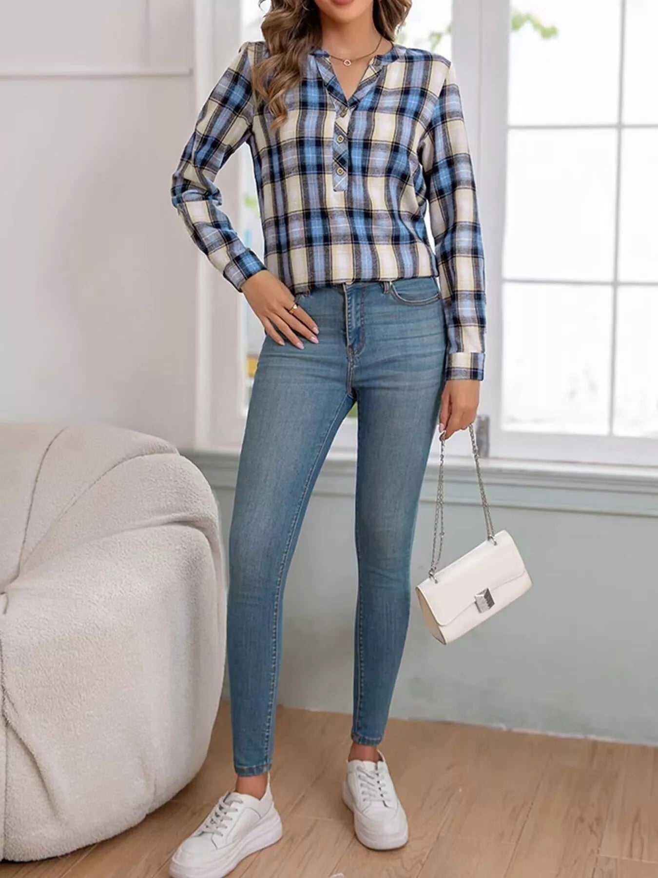 Plaid long sleeve blouse with half button closure, made of polyester and spandex blend.