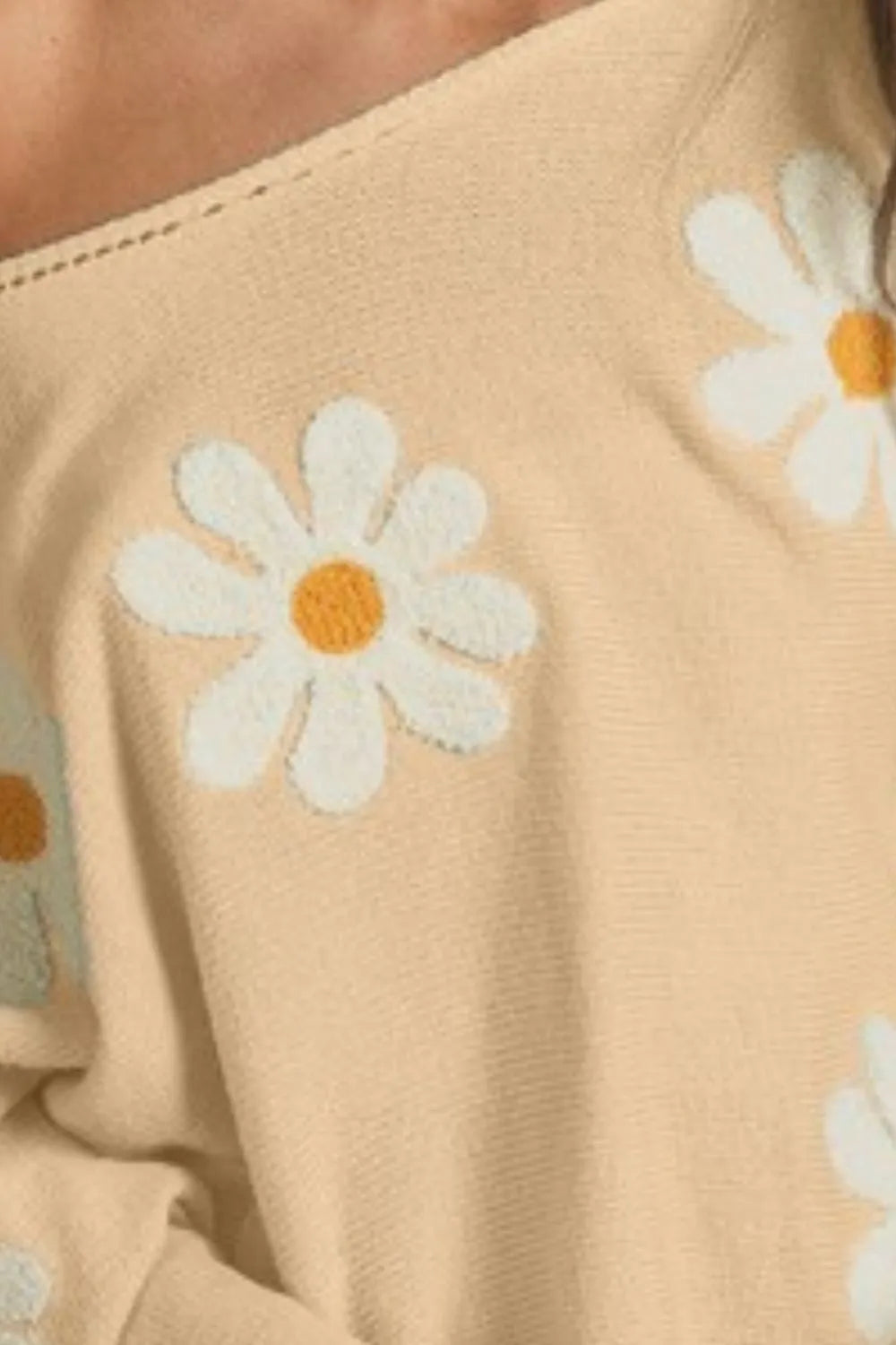 BiBi loose fit knit top in beige with white daisy embroidery.
