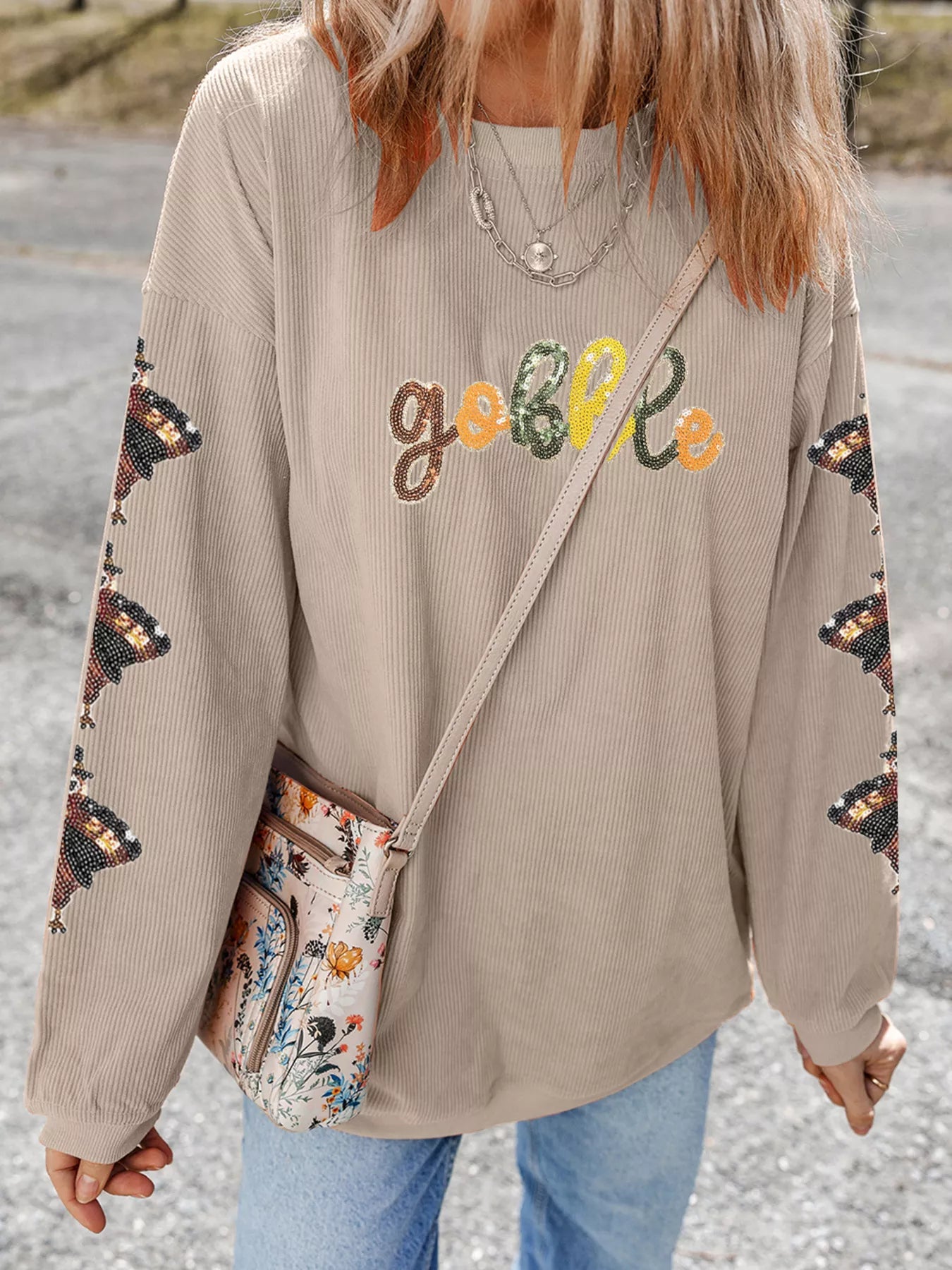 Beige ribbed sweatshirt with "Gobble" text, turkey sequins on sleeves.