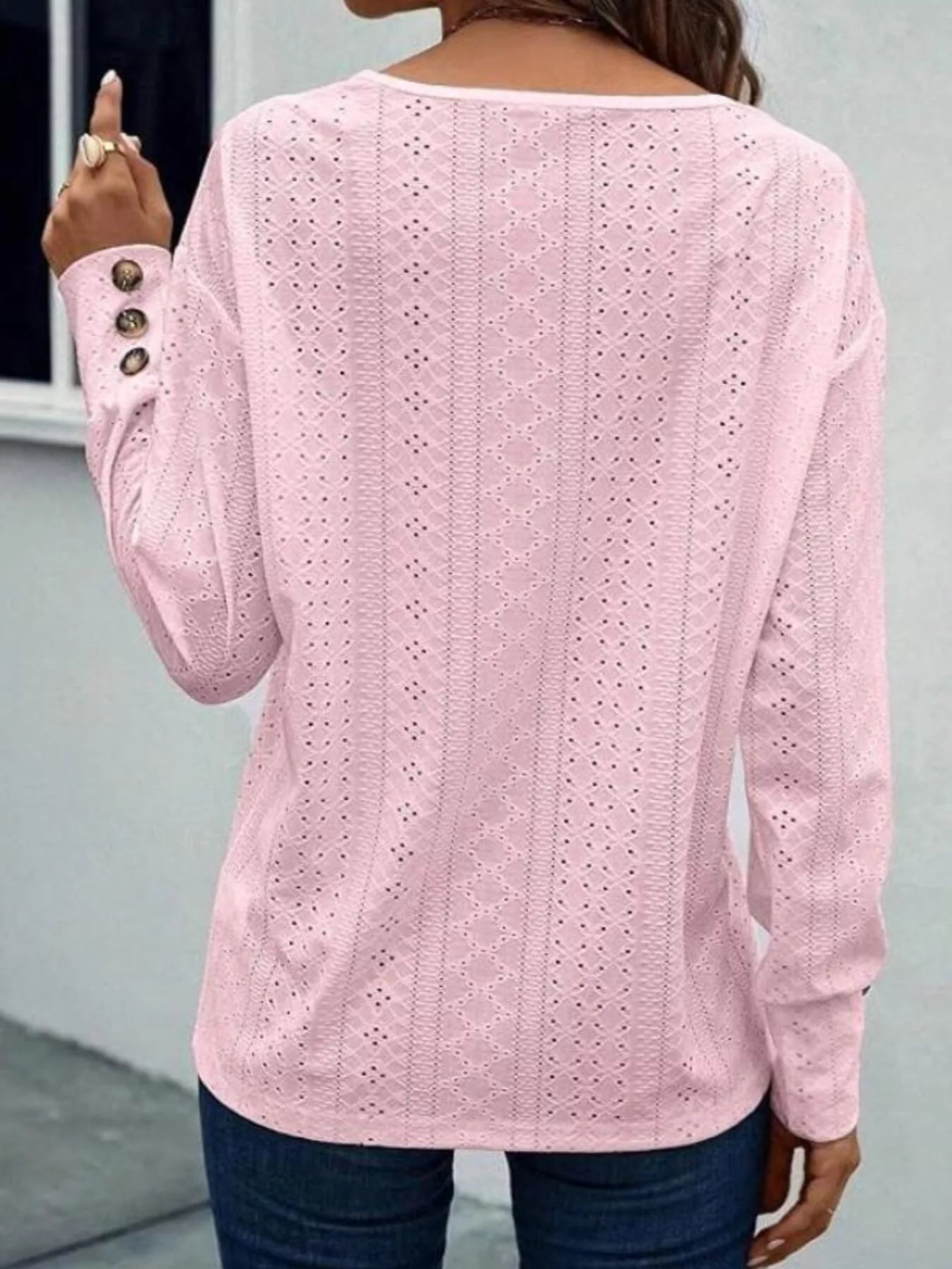 Long sleeve polyester blend blouse with eyelet details and V-neckline in white color.