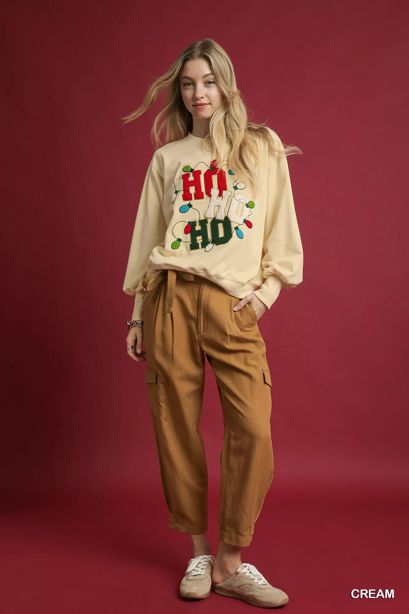 Cream-colored French terry sweatshirt with HO applique and khaki cargo pants on model.