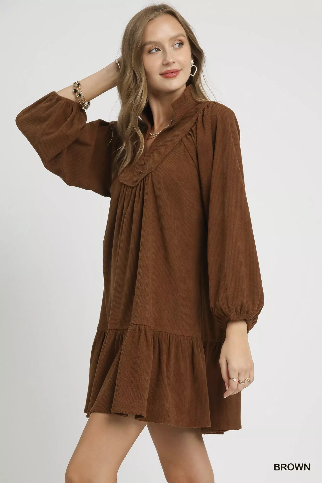 Brown corduroy tiered babydoll dress with long bishop sleeves and V-neck.