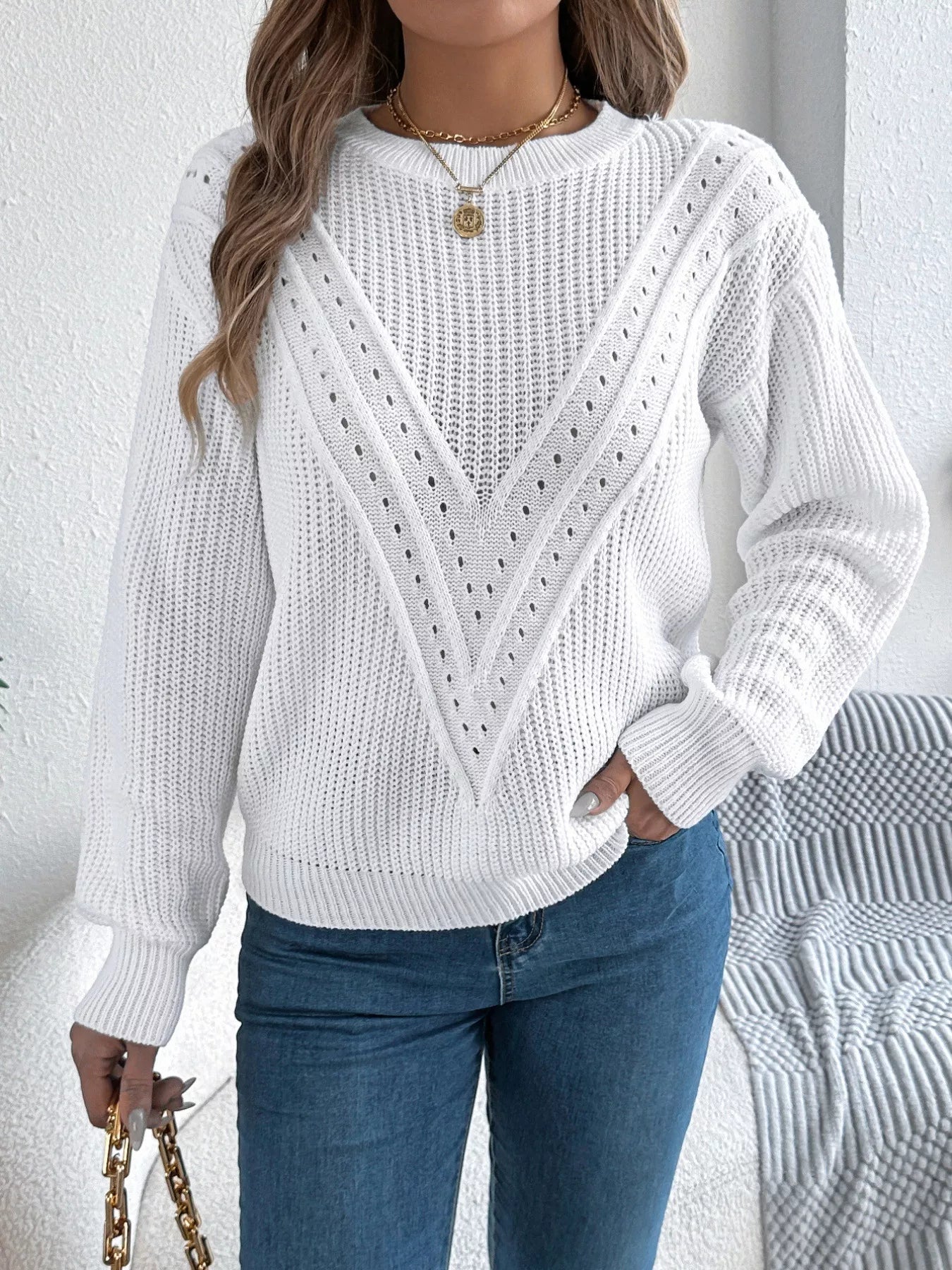 Openwork acrylic sweater with a round neck and slightly stretchy, breathable knit.