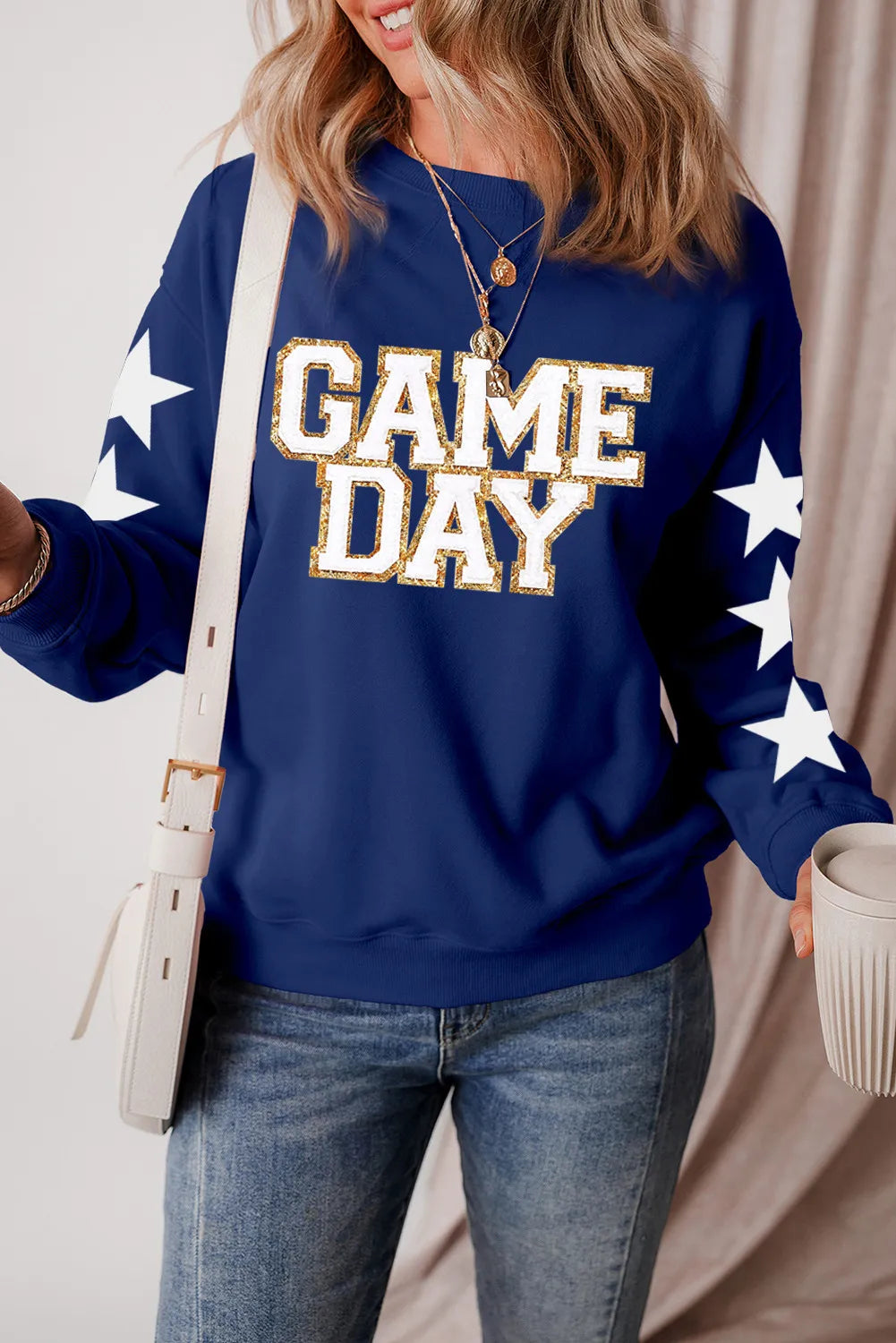 Long sleeve cotton blend sweatshirt with glitter star design and opaque fabric.