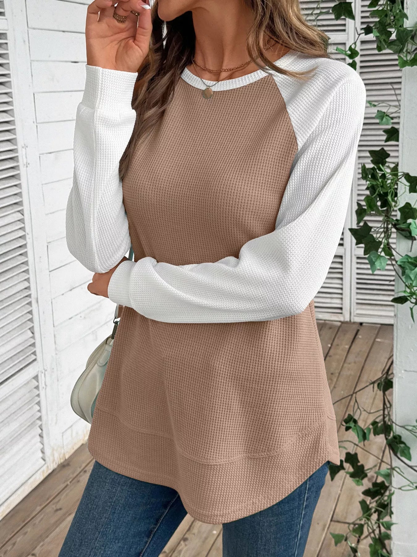 Waffle knit t-shirt with contrast raglan sleeves and slightly stretchy fabric.