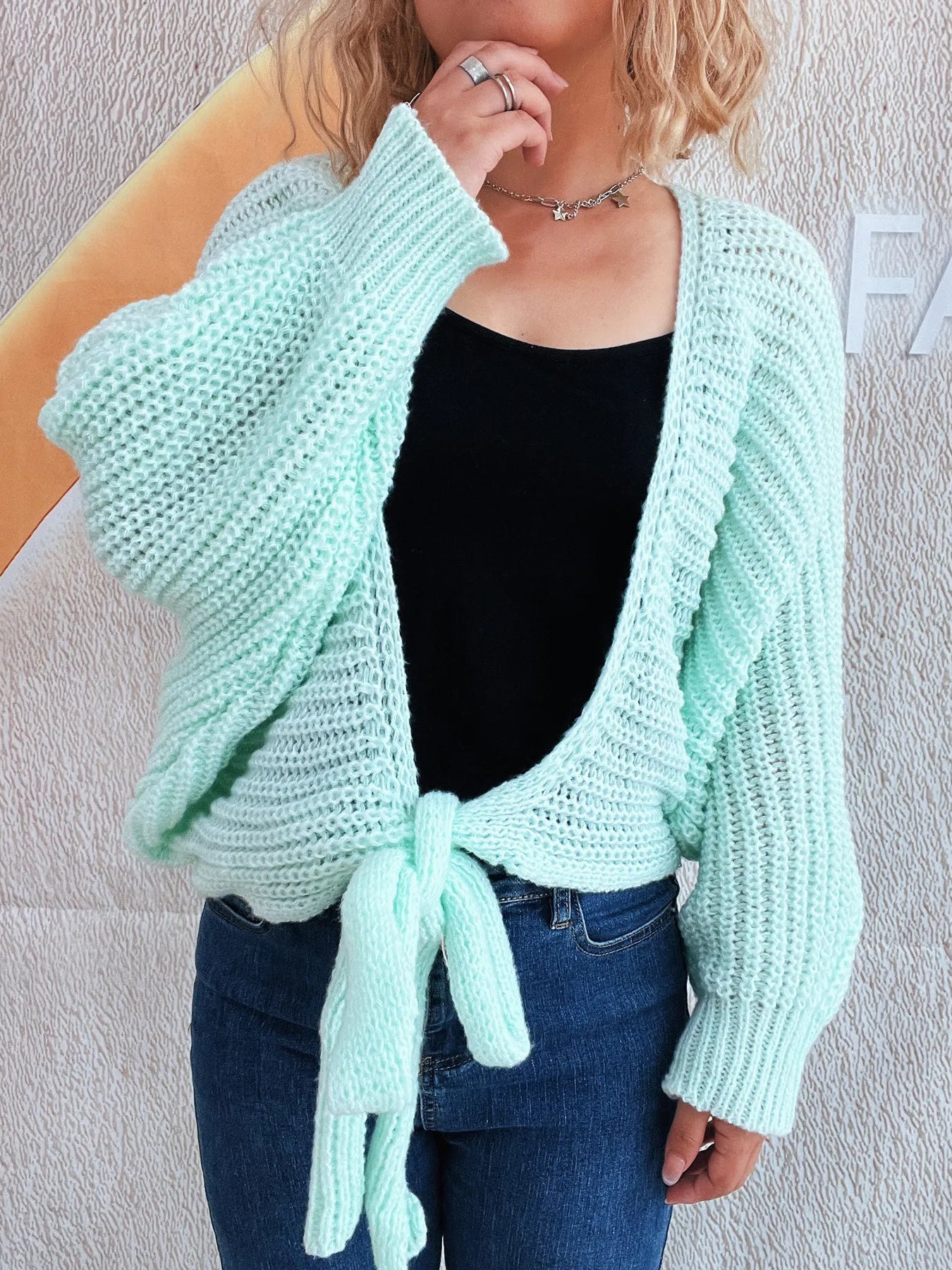 Light blue tie-front long sleeve knit cardigan on a model.