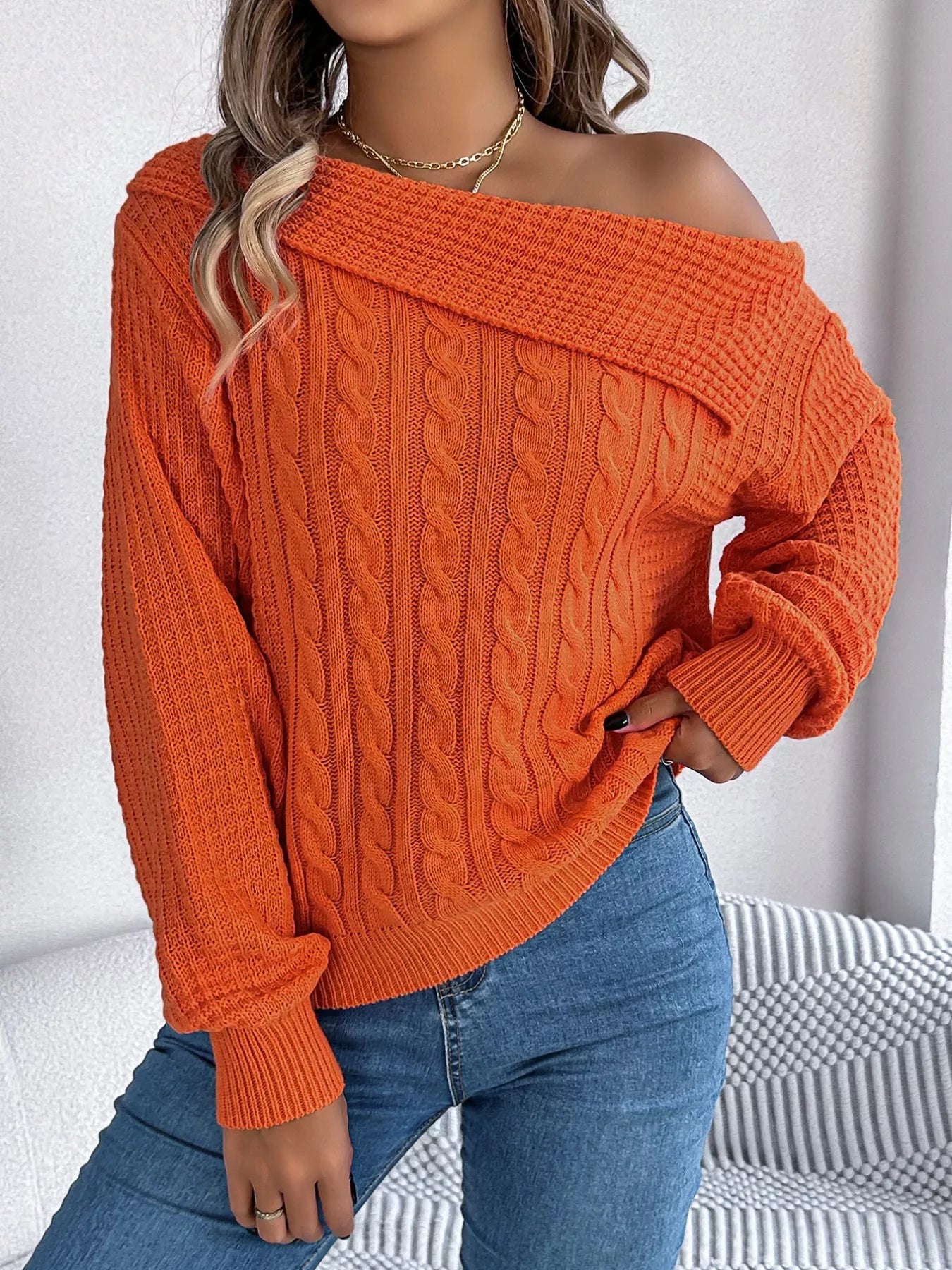 Cable knit off-shoulder sweater in soft acrylic with slight stretch and classic texture.