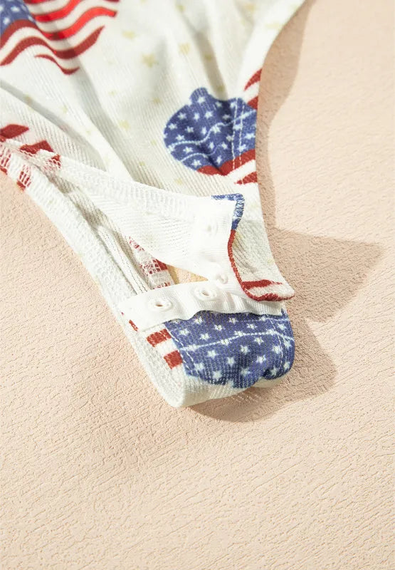 Sheer mock neck long sleeve bodysuit with US flag heart design and slightly stretchy fabric.