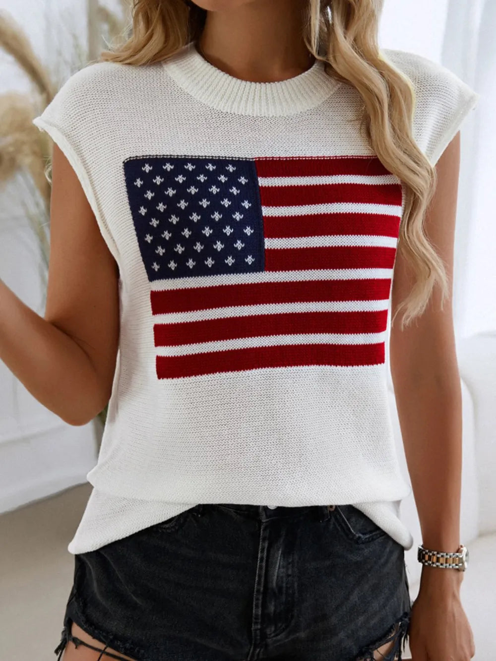Polyester sweater vest with US flag design and round neck, moderate stretch fabric.