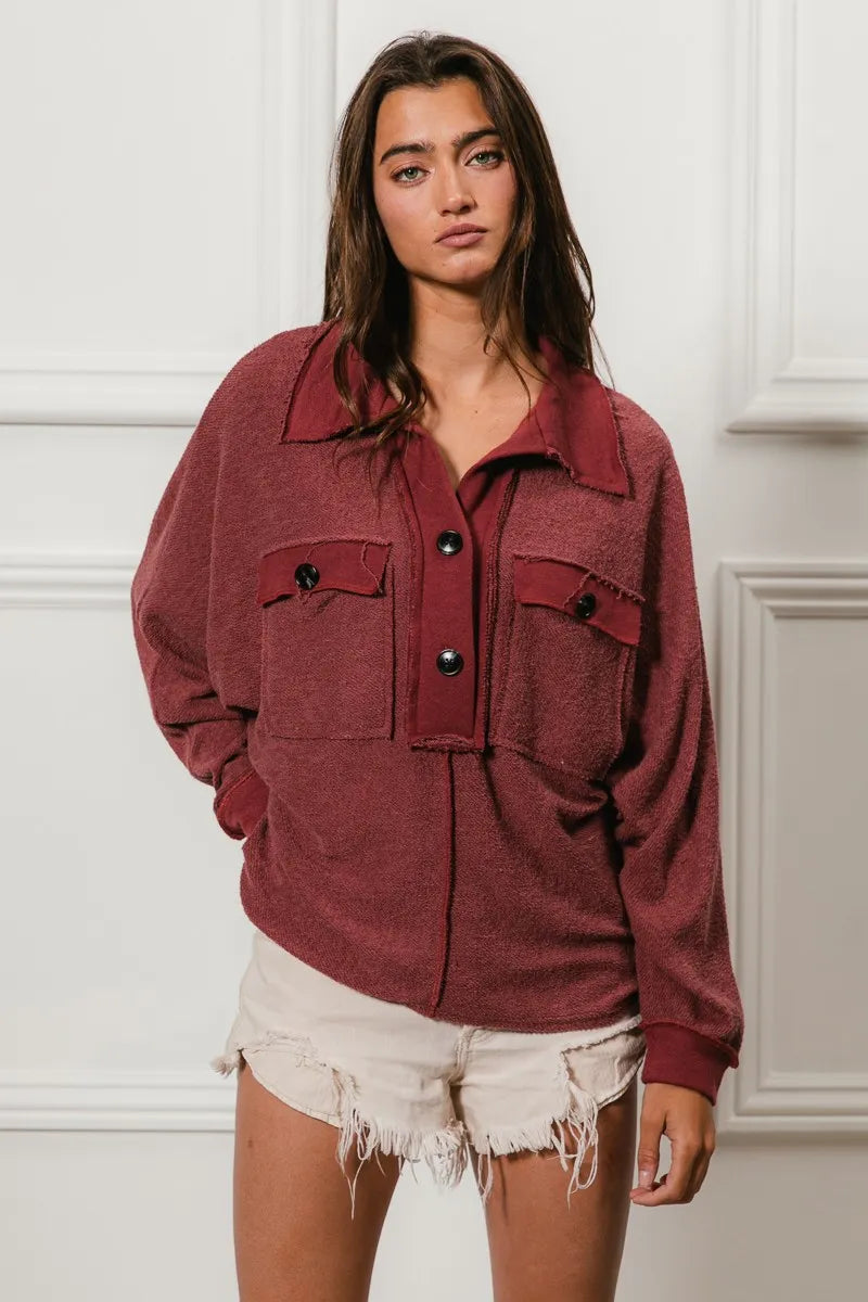 Oversized maroon French terry collared top with buttons and pockets, model wearing.