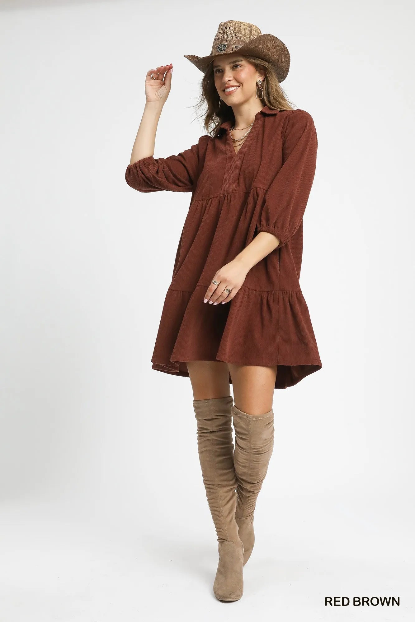 Woman modeling a red-brown tiered corduroy mini dress with balloon sleeves, cowboy hat, and knee-high boots.