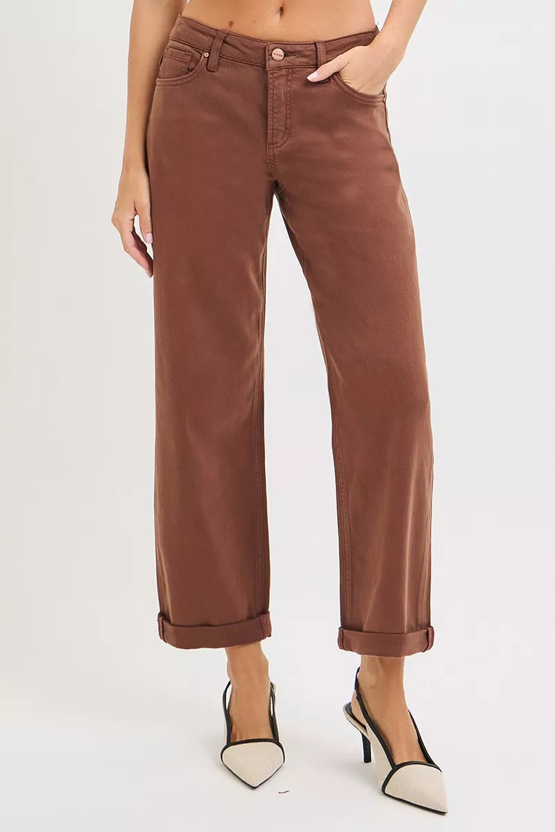 Brown wide-leg high-rise jeans with cuffed hems on a plus-size model.