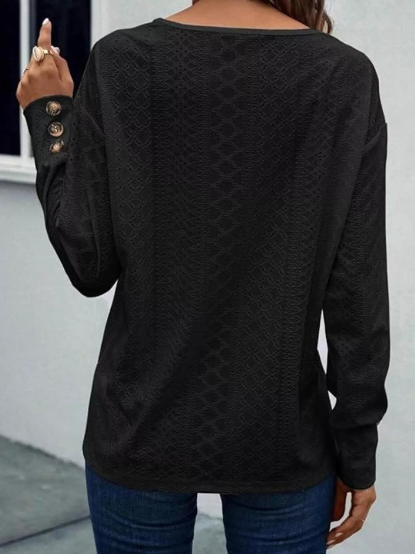 Long sleeve polyester blend blouse with eyelet details and decorative buttons in V-neck style
