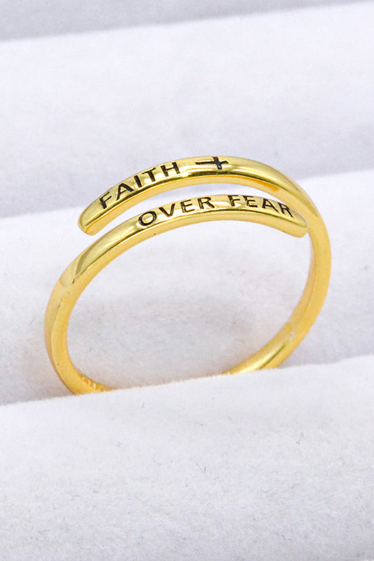 Gold-plated sterling silver bypass ring engraved with "Faith Over Fear" and a cross.