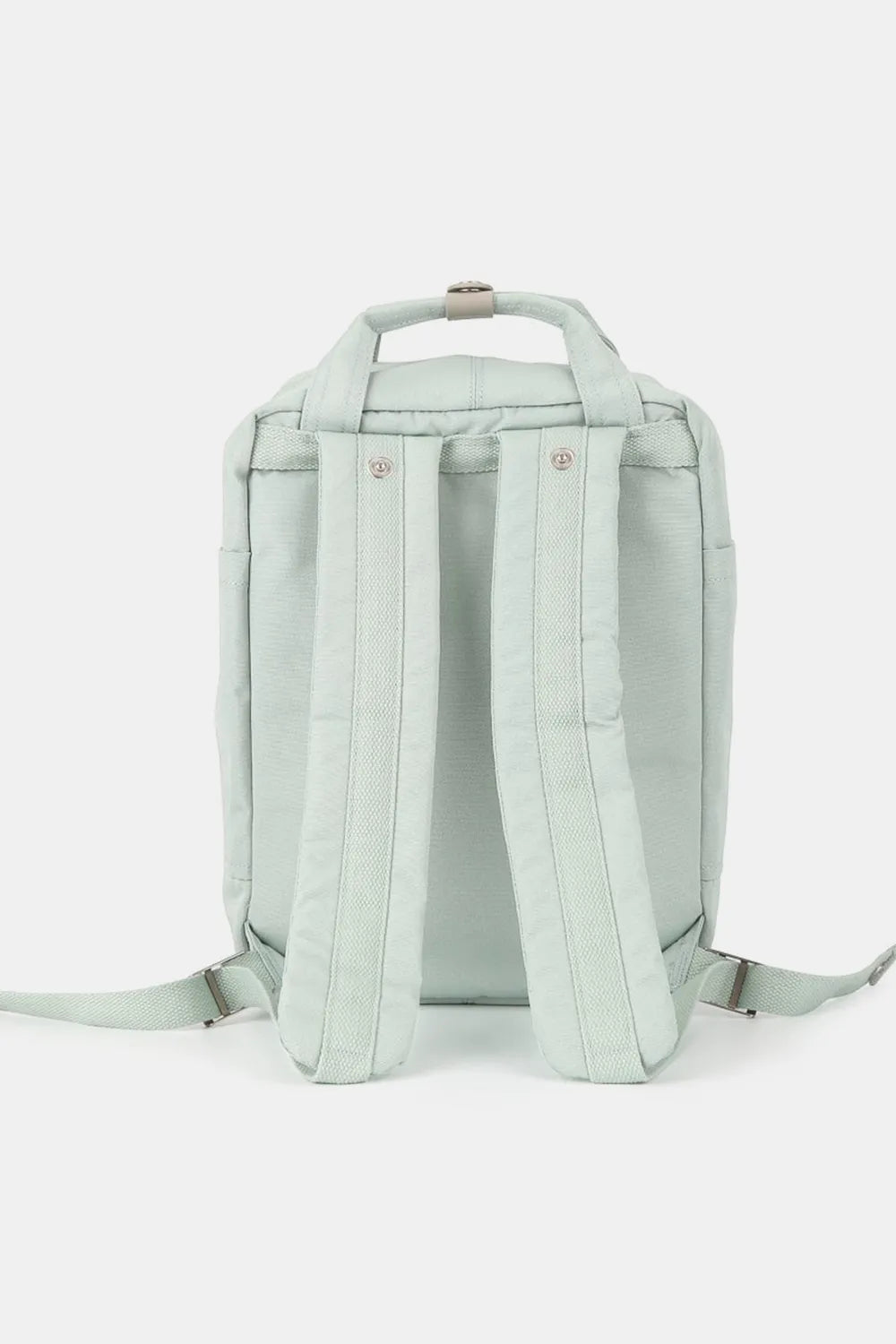 Rear view of a light green water-resistant nylon backpack with padded straps and top handle.
