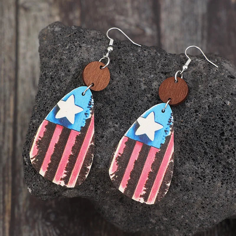 Wooden dangle earrings featuring a star and stripes design made of alloy and wood.