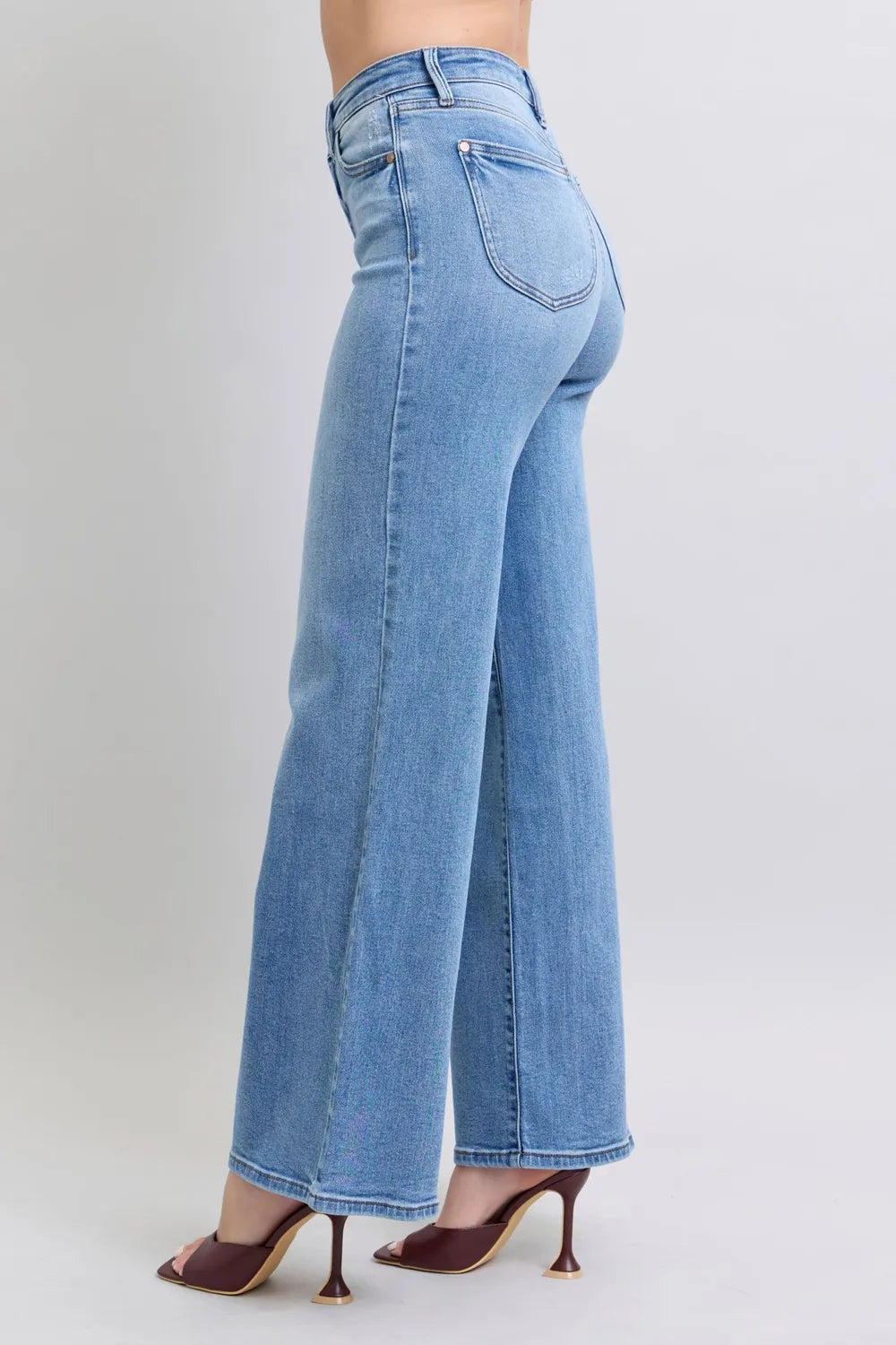 Side view of Judy Blue high-waist wide-leg jeans with pockets, modeled on a woman.