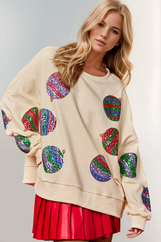 Cream long-sleeve sweatshirt with colorful sequin Christmas ornaments.