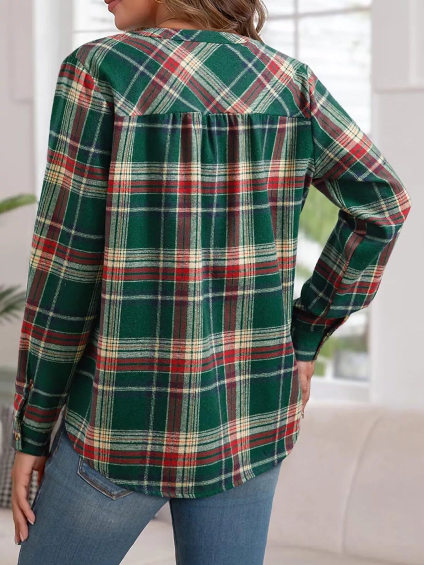 Plaid long sleeve blouse with half button closure, made of polyester blend fabric.