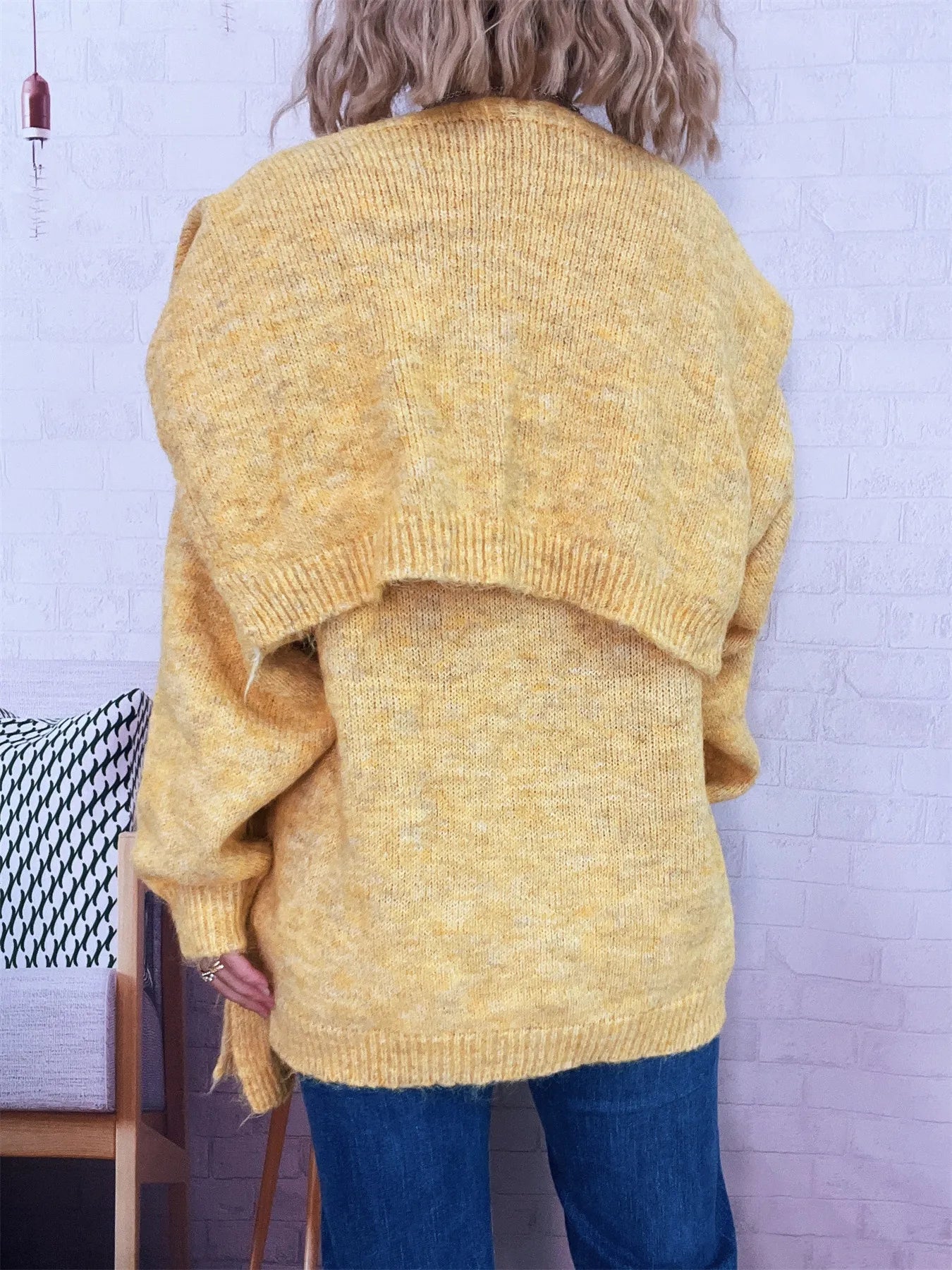 Ribbed hem V-neck sweater with shawl in a slightly stretchy 100% polyester fabric.