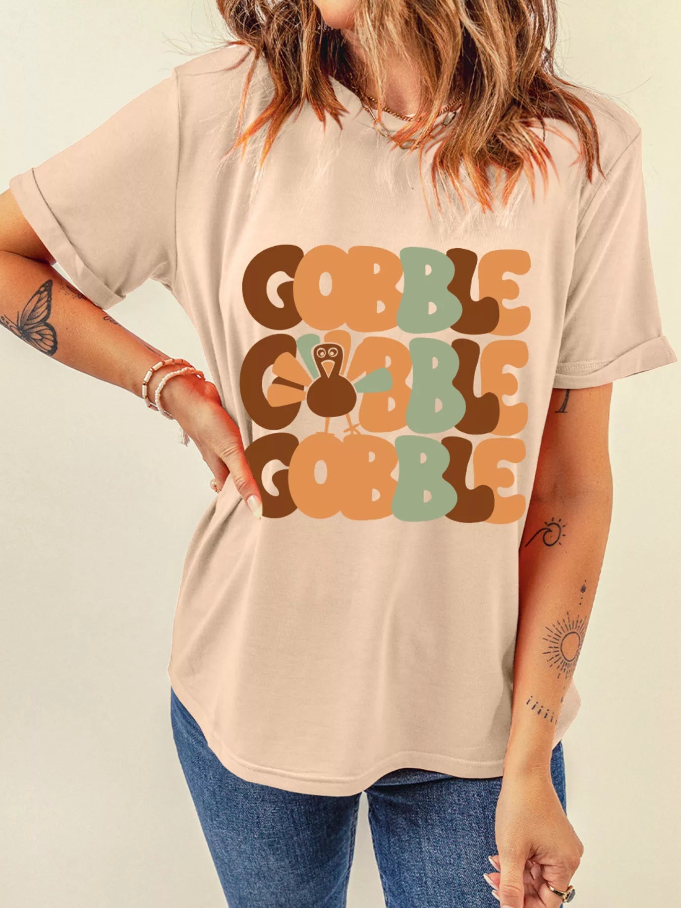 Beige round neck T-shirt with stacked "Gobble" text and turkey graphic.