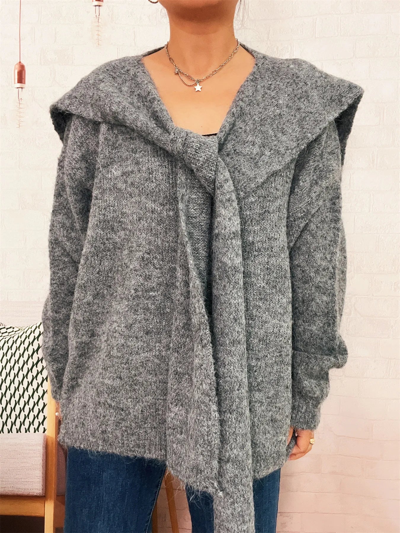 Ribbed hem V-neck sweater with shawl collar in soft, slightly stretchy polyester.