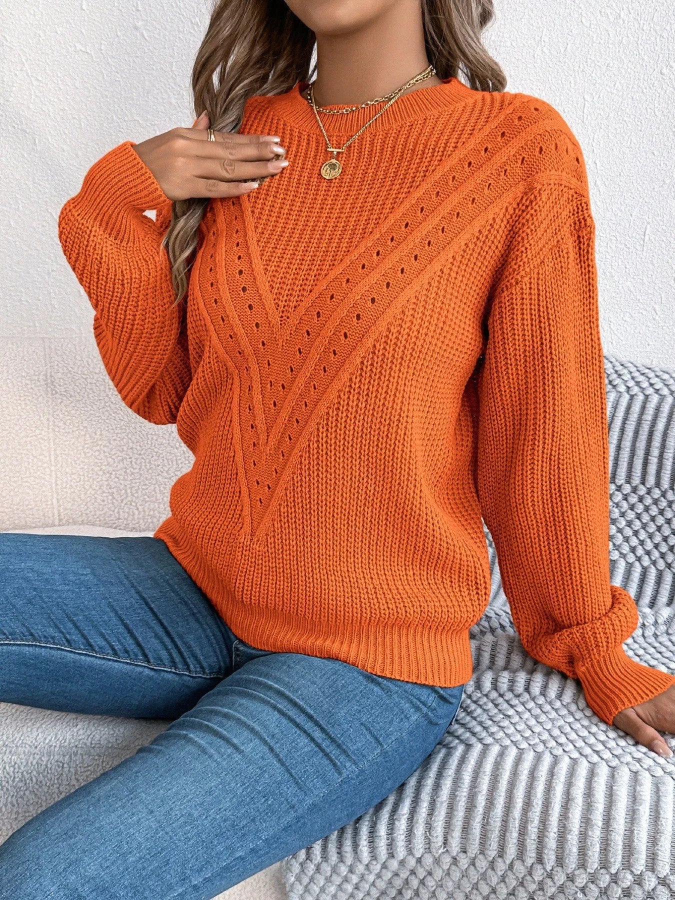 Lightweight openwork acrylic sweater with a round neck and slightly stretchy fit.