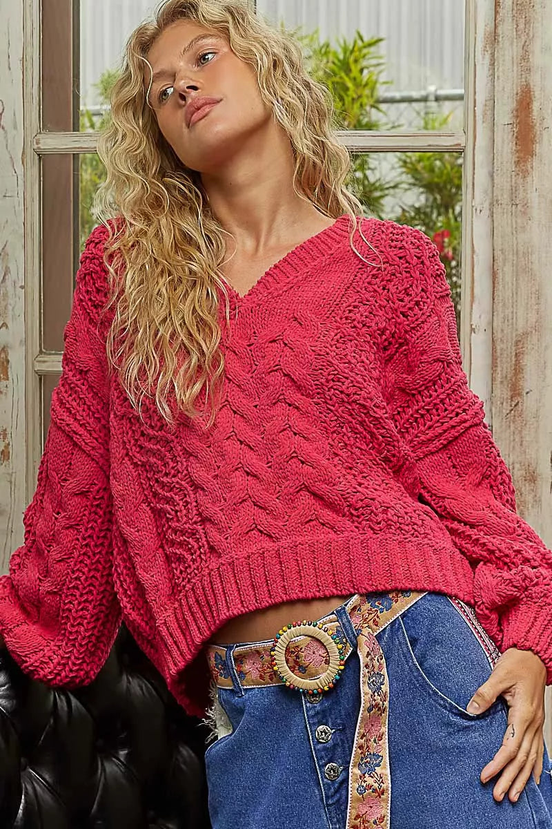 Red chenille cable-knit V-neck cropped sweater with balloon sleeves.