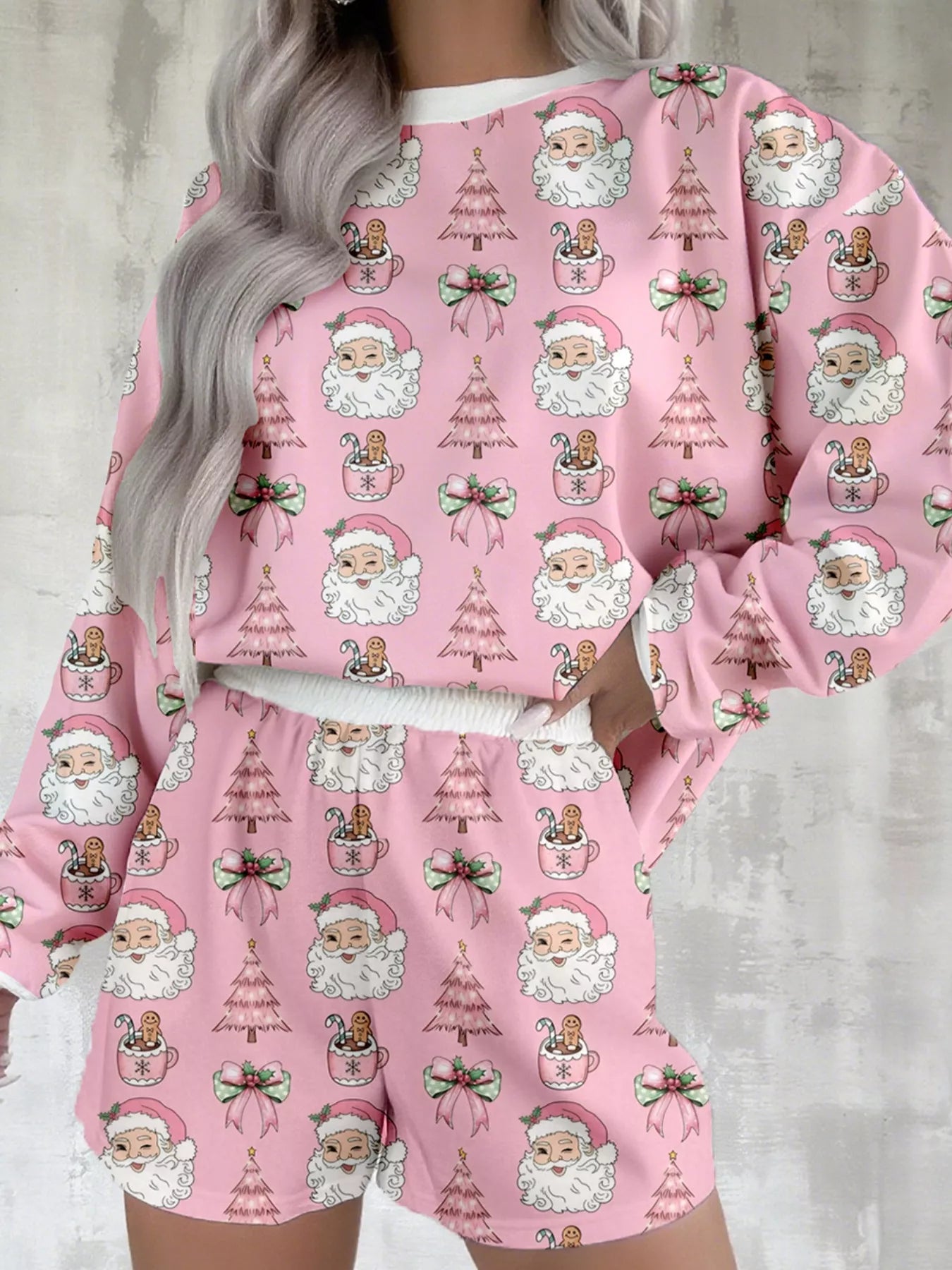 Pink two-piece lounge set with festive Santa and Christmas tree print.