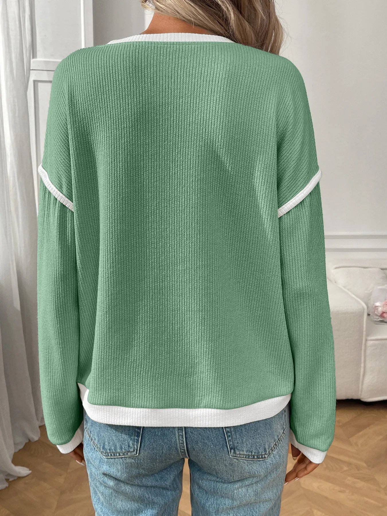 Ribbed long sleeve top in stretch fabric with contrast trim and subtle texture.