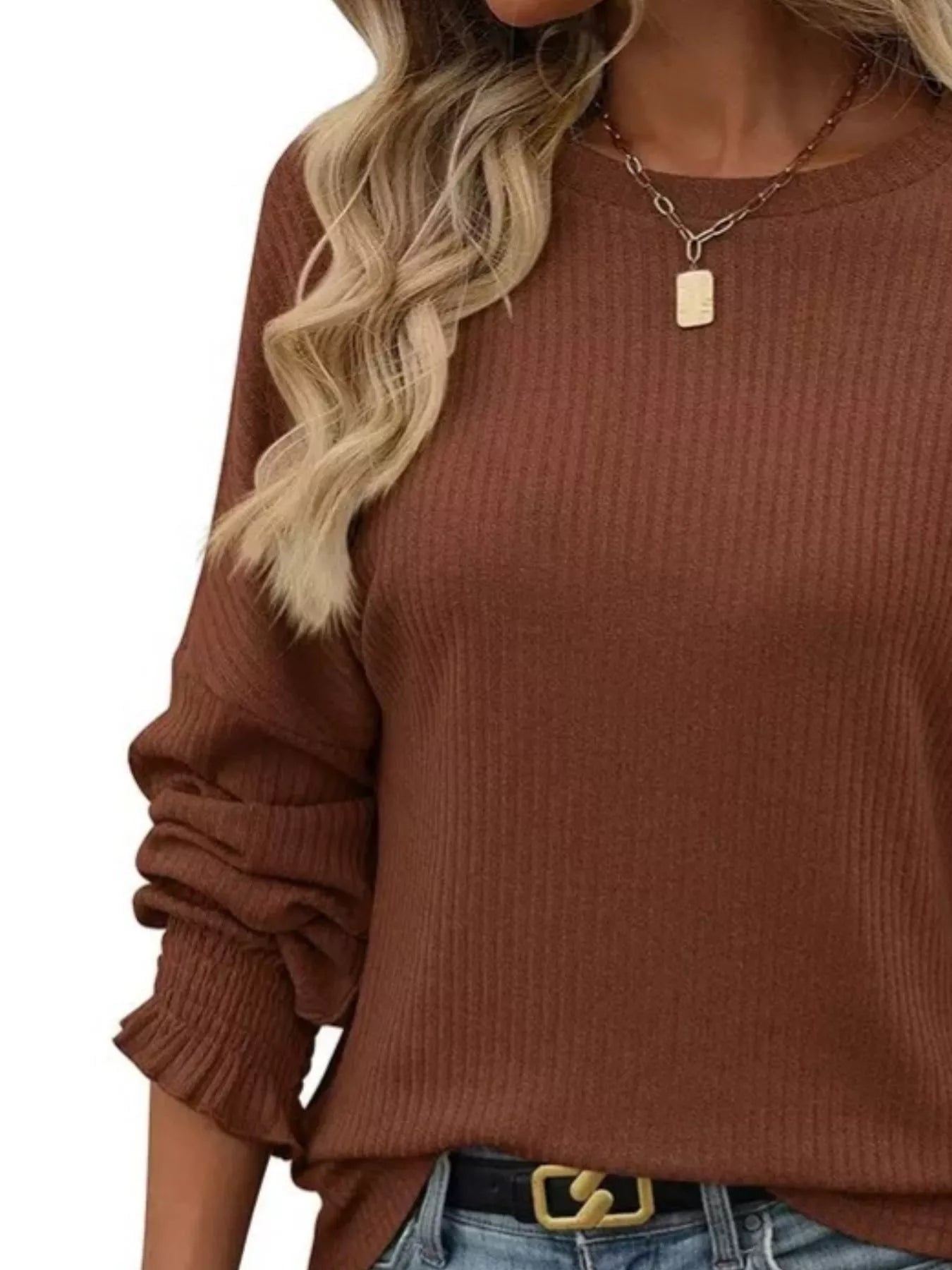Ribbed long sleeve t-shirt made of a stretchy polyester blend in various sizes.