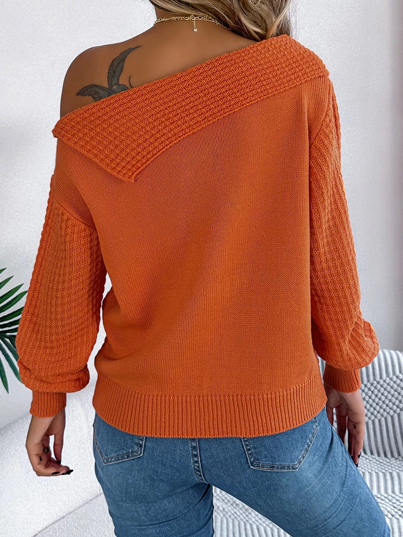 Off-shoulder cable knit sweater in soft, slightly stretchy acrylic with a classic texture.