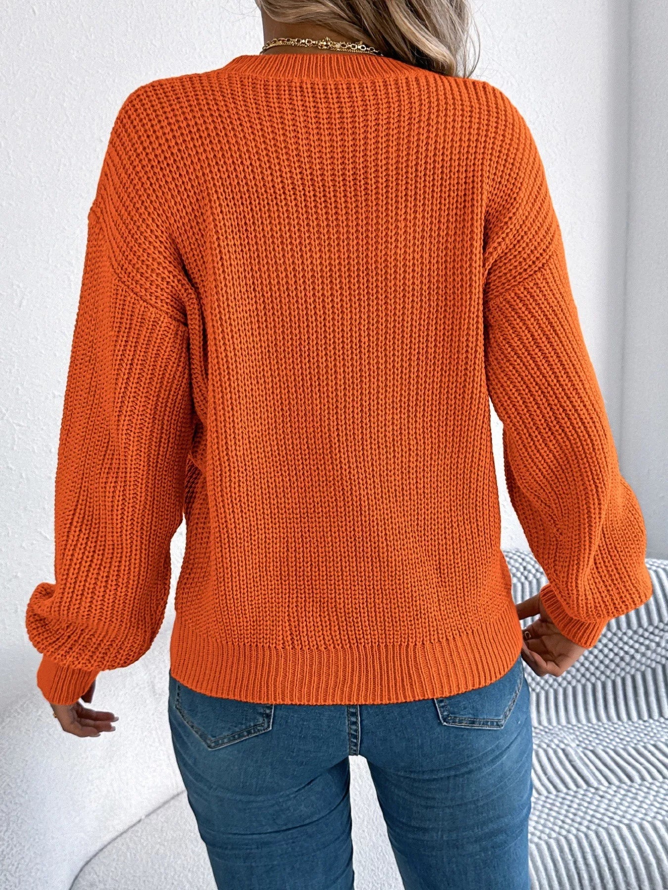Lightweight openwork acrylic sweater with a round neck and slightly stretchy fit.