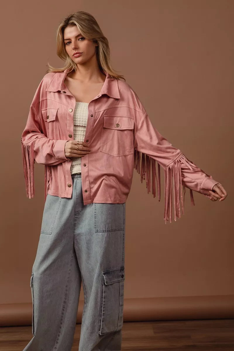 BiBi suede fringe long sleeve jacket in pink, modeled with wide-leg jeans.