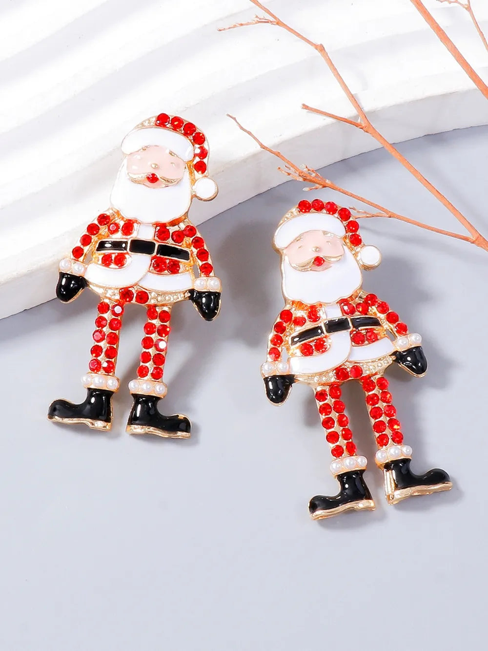Pair of alloy Santa Claus earrings with red rhinestones and black boots.