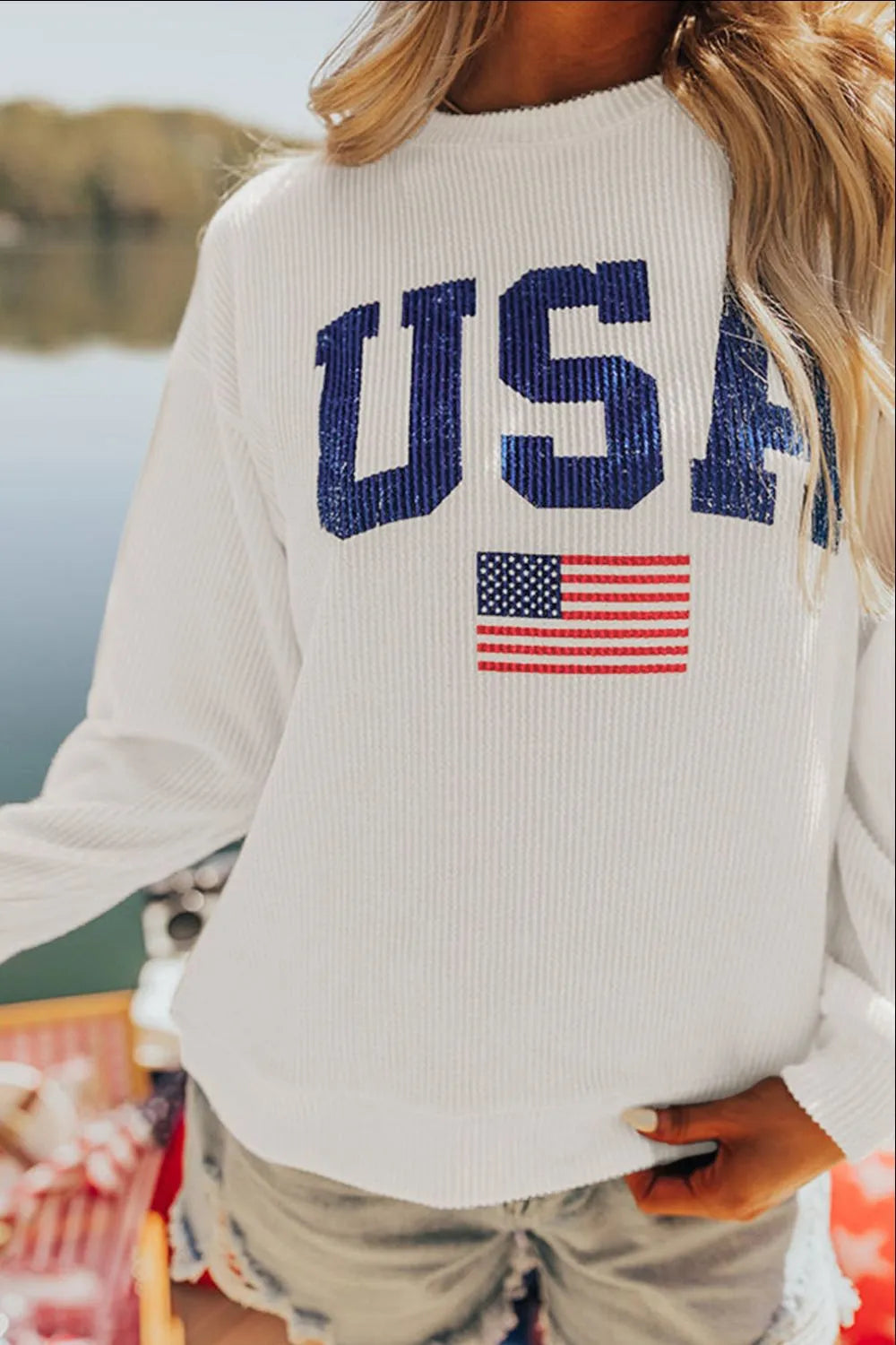 Long sleeve sweatshirt with US flag design in a polyester blend fabric.