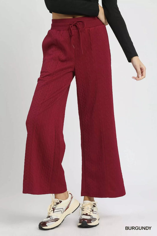 Burgundy cable knit textured wide leg pants with drawstring waist.