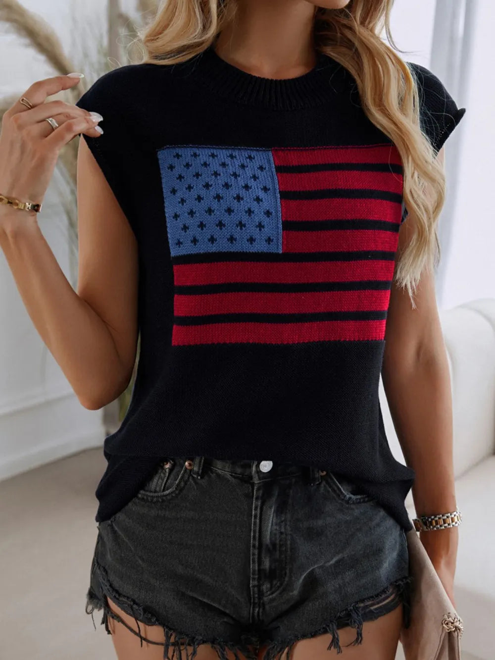 Red, white, and blue US flag sweater vest with round neck and moderate stretch.