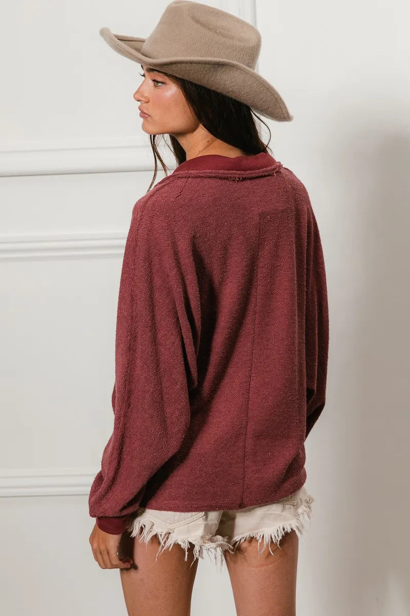 Oversized maroon French terry collared top with cut edge details, modeled from behind.