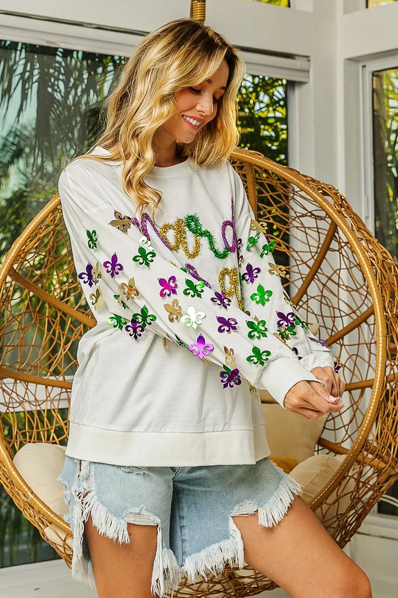 Fleur De Lis Sleeve Pullover in soft fabric with intricate sleeve designs for Mardi Gras celebrations.