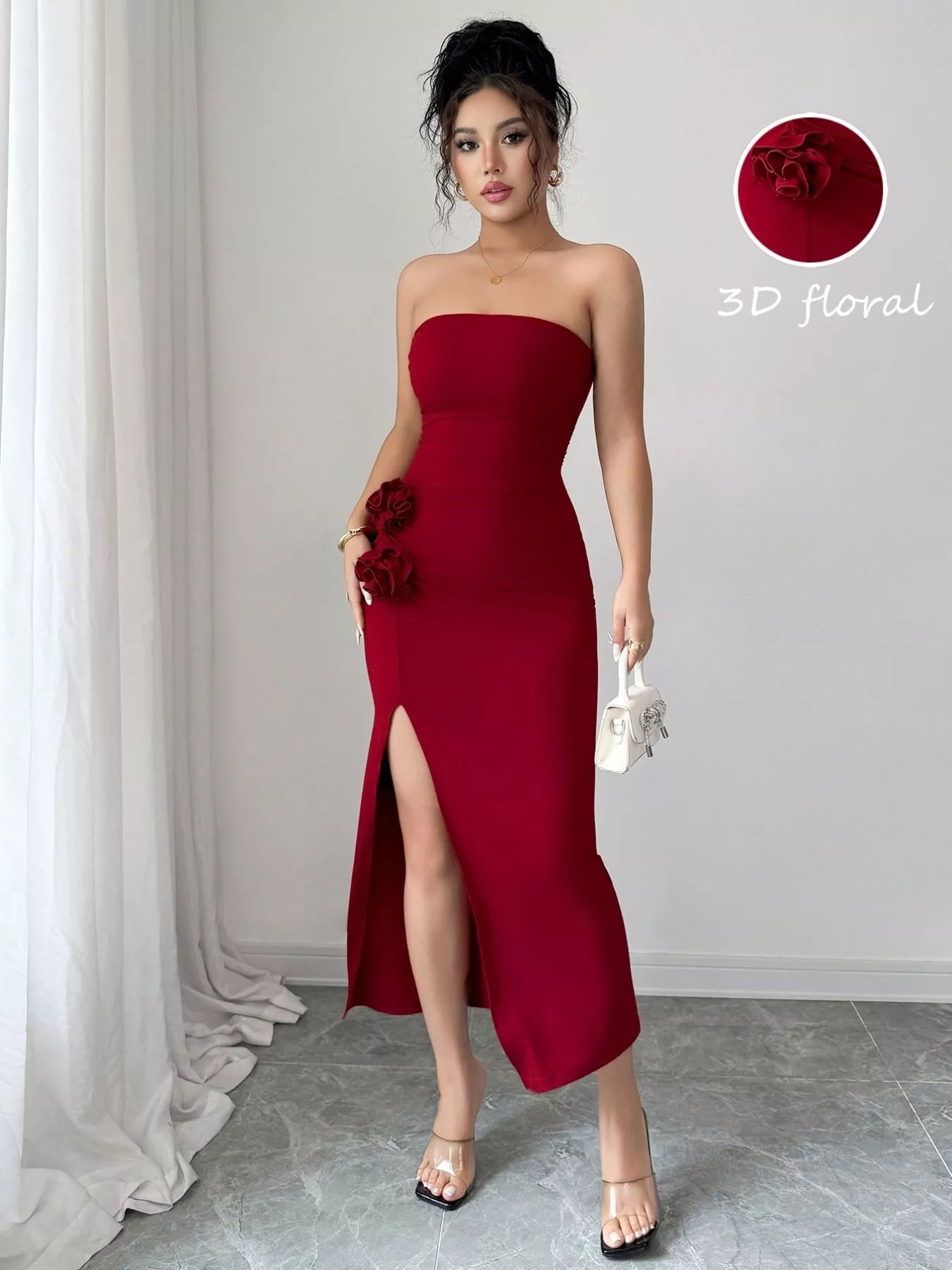 Navy blue strapless dress with a front split and floral detail, perfect for elegant occasions.