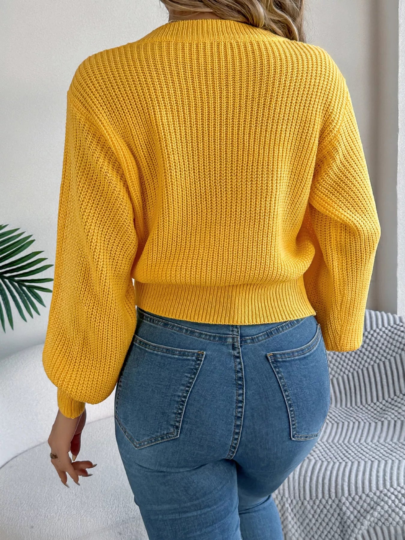 Long sleeve acrylic sweater with cable knit diamond pattern in neutral color