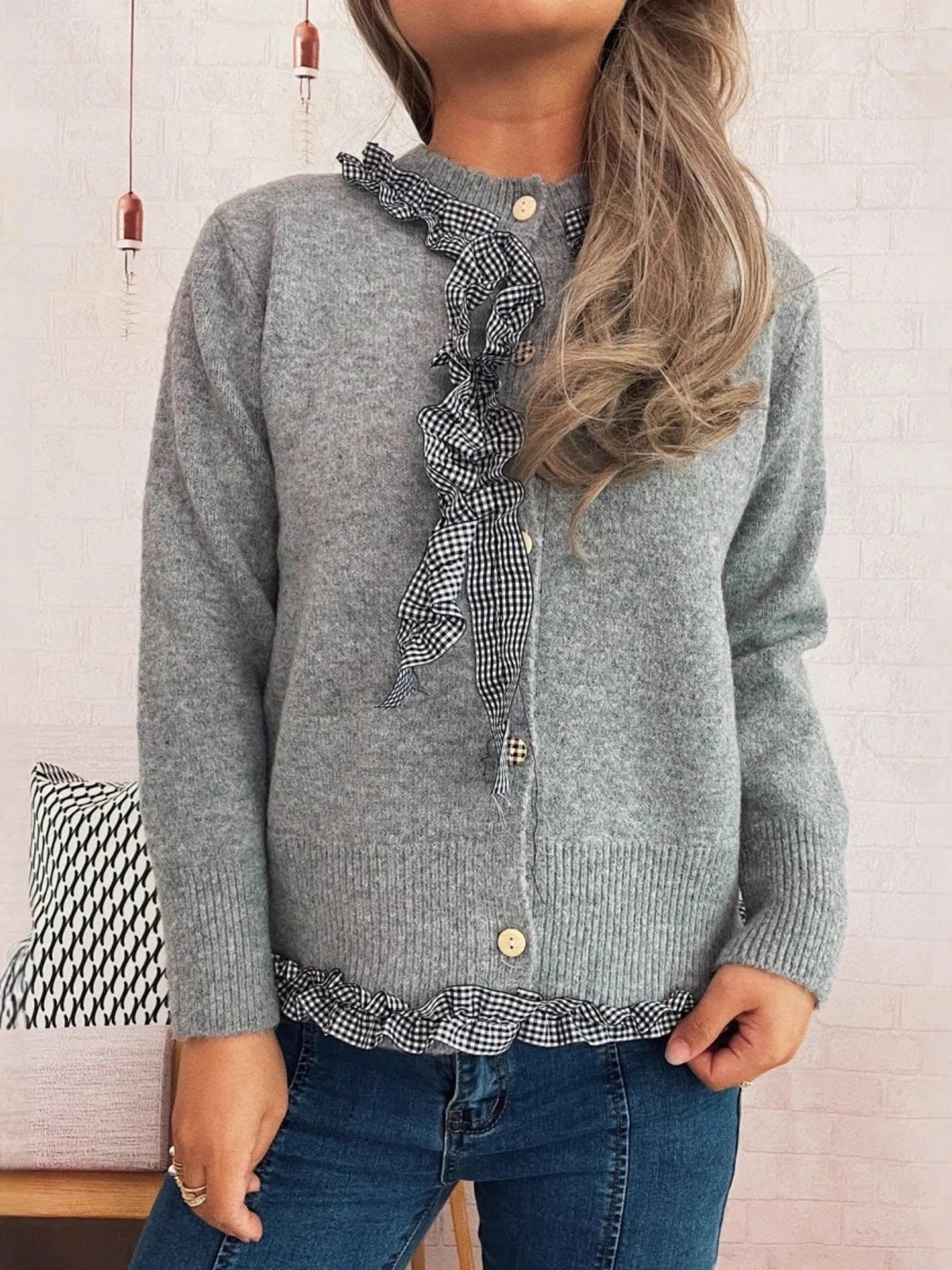Lightweight gingham cardigan with ruffle trim and button closure, made of 100% polyester.