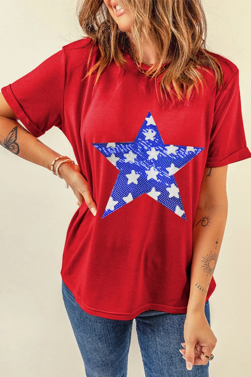 Short sleeve T-shirt with sequin star design and sheer stretch fabric in light color.